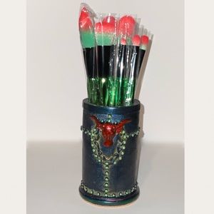 Seven piece make up brush sent with container.